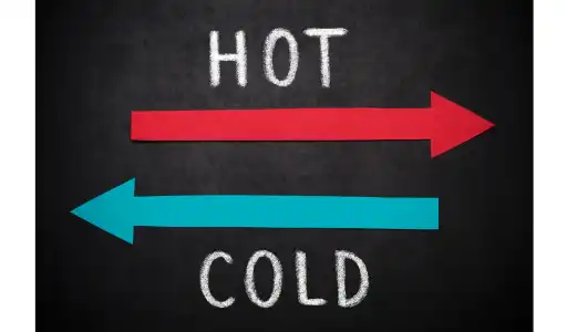 Schematic representation of heat transfer from a hot region to a cold region, illustrating the natural direction imposed by the Second Law of Thermodynamics.